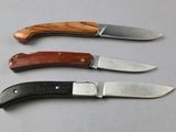 three different types of knives are lined up on a table
