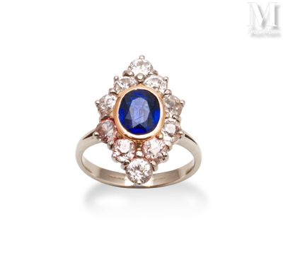 a close up of a ring with a blue stone surrounded by diamonds