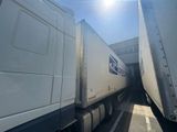 two semi trucks that are parked next to each other