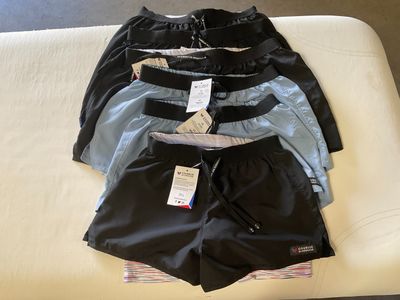 three pairs of men ' s boxer shorts sitting on a bed