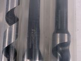 two drill bits in a plastic container on a table