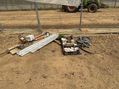 un tracteur garé sur la terre battue, près d'une clôture