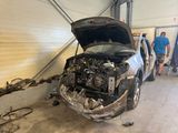 a car that is in the garage with its hood open