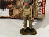 toy figurine of a man with a gun in front of a box