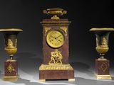 three vases and a clock sitting on a table