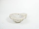 a white marble bowl sitting on a white surface