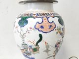 a white vase with a bird on it on a table