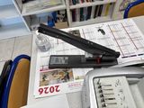 an image of a stapler on a desk with a lot of office supplies