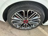 a close up of a tire on a white car