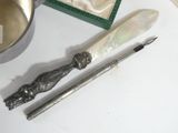 a silver spoon and a knife on a table next to a box