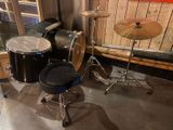 a drum set up in the corner of a room