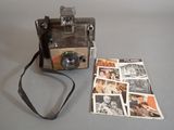 an old photo of a polaroid camera and a magazine