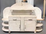 a small white cabinet with a mirror on top of it