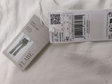 a white shirt with a price tag attached to it