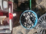 a blue bowl filled with nuts and bolts on a table