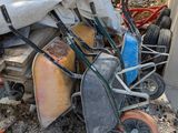 a pile of junk on the ground next to a building