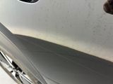 a dog that is looking out the window of a car