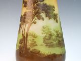 a vase with a painting on it sitting on a table