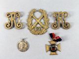 three medals and a medal laying on a table next to a coin