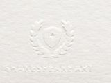 a close up of a white paper with a crest on it