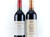 two bottles of wine that are sitting next to each other