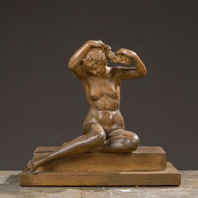bronze sculpture of a man drinking from a bottle on a marble base