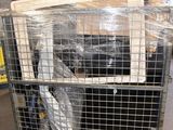 a cage with a bird inside of it in a warehouse