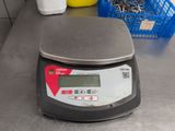 a digital scale sitting on a counter in a kitchen