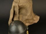an old helmet and a sack of burlock on a black background