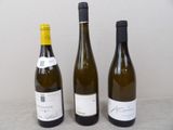 three bottles of wine sitting next to each other on a table