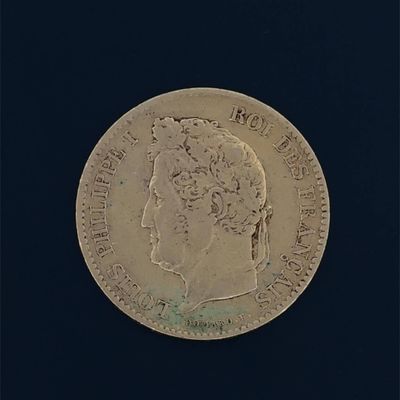 an old gold coin with a portrait of a man on it