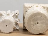 two white vases sitting next to each other on a table