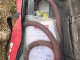 a bag with a hose in it sitting on the ground