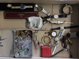 a box filled with assorted items and a watch
