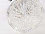 a glass vase with a flower inside of it