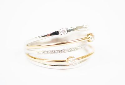 two gold and silver rings with diamonds on a white background