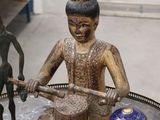 a statue of a man playing a musical instrument on a table