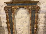 a picture of a mirror in a room with a stone wall