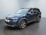 Le SUV bleu est garé dans une grande pièce au sol noir.