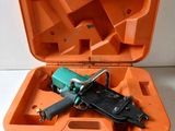 an orange case with a stapler and a stapler in it