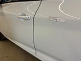 a white car with a sticker on the side of it
