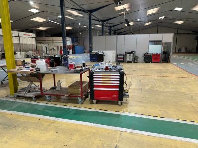 an image of a warehouse with a lot of tools on the floor