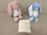 two stuffed animals sitting next to each other on a couch