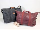 two bags sitting next to each other on a white surface