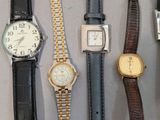 many different types of watches displayed on a table