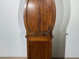 a grandfather clock that is standing in the corner of the room