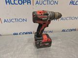 a drill is sitting on top of a table in front of a sign