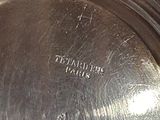 a silver plate that has a tag on it