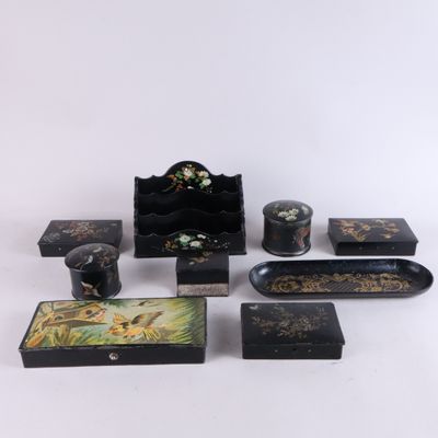 several pieces of black and gold painted furniture on a white surface