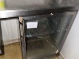 stainless steel counter top in a commercial kitchen with a glass door